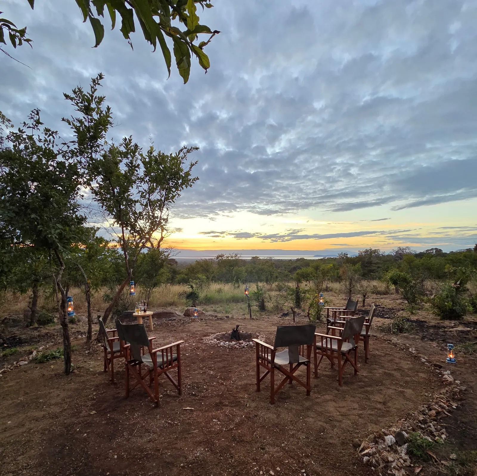 Campfire lounge at dusk, Lake Burunge on the horizon
