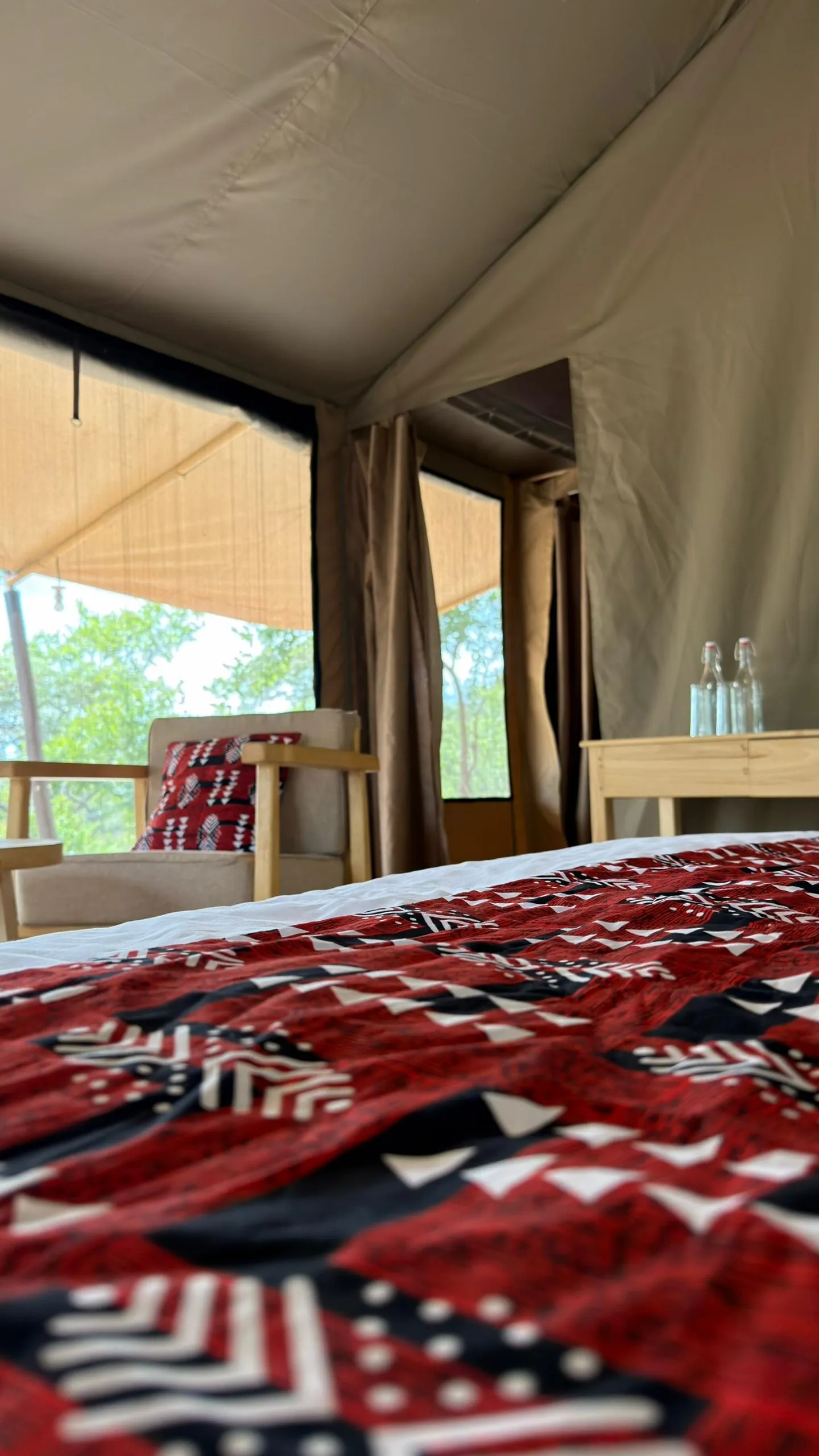 Bed and armchair in a guest tent